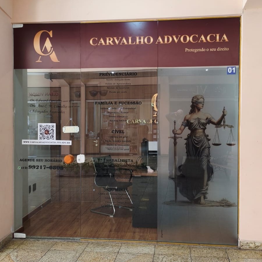 Entrada do escritório Carvalho Advocacia: porta de vidro com o letreiro do escritório e a relação das áreas de atuação